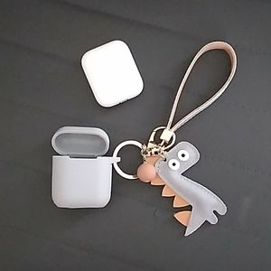 Apple airpods included with a dinosaur case